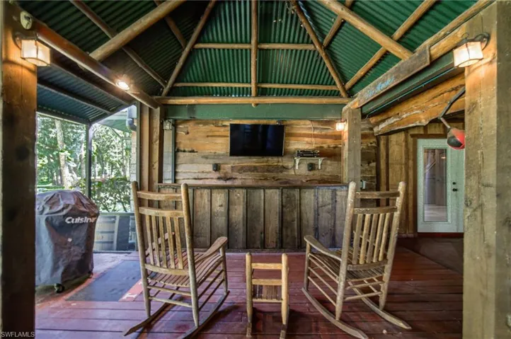 Covered bar and gathering area within the outdoor living space