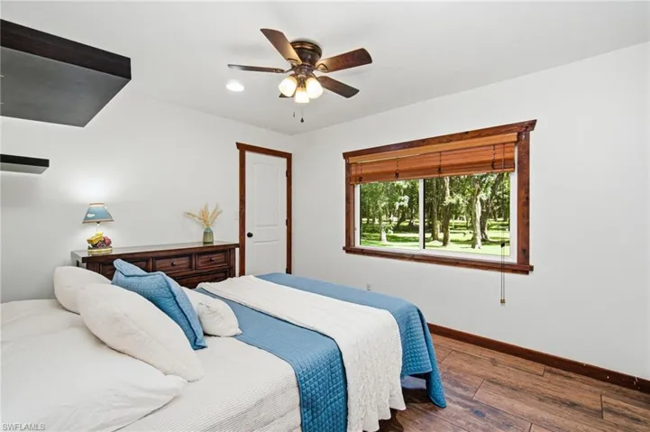 Guest bedroom with window, ceiling fan and neutral finishes