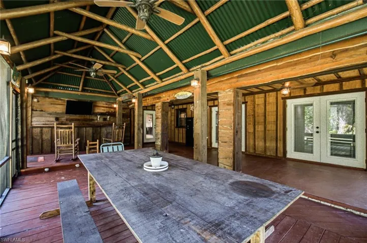 Expansive covered outdoor space with wood finishes and room for multiple seating or activity areas