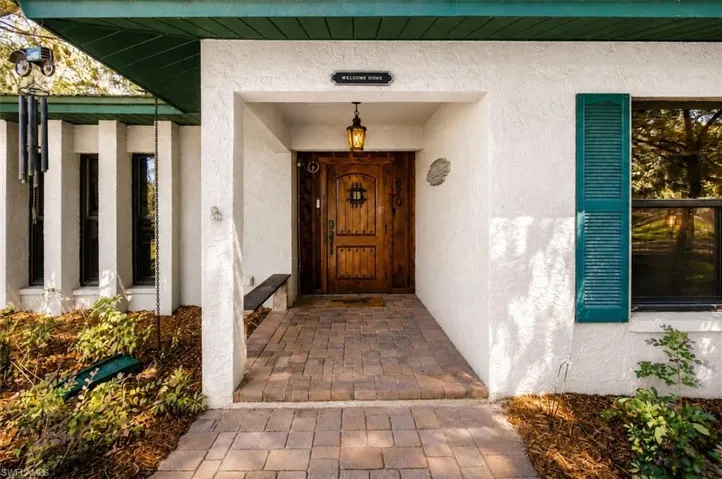 Covered front entry with wood door and walkway