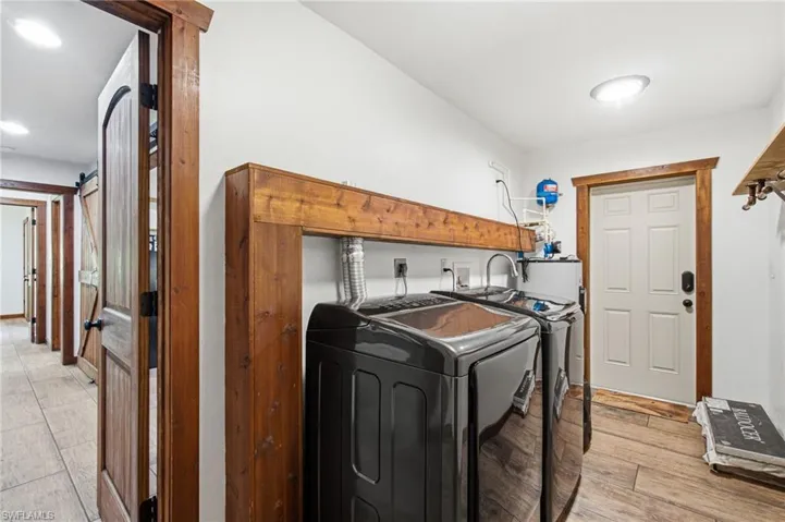 Interior laundry area with washer, dryer and laundry sink