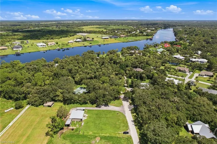 Elevated view showing the property and near by waterway within the broader landscape