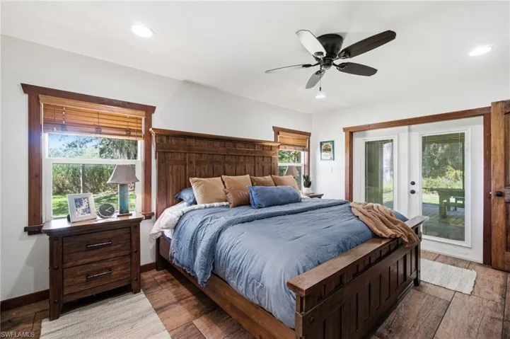 Primary bedroom with abundant natural light, ceiling fans and french doors