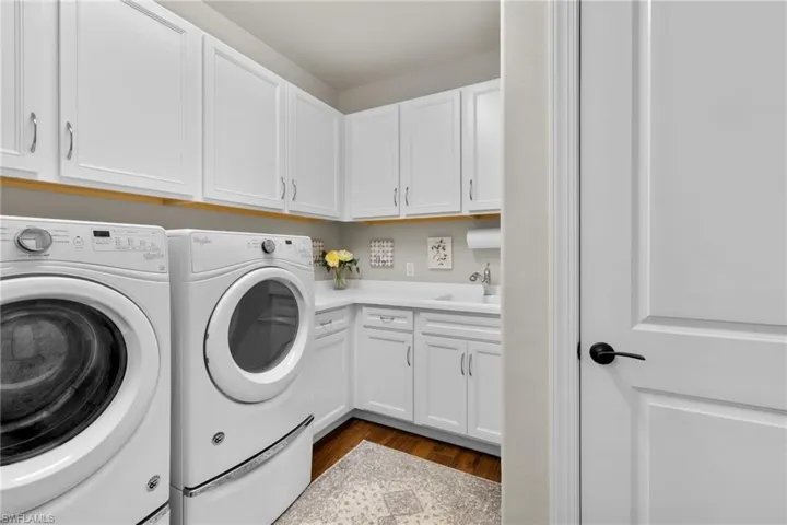 Spacious Laundry room with tons of cabinets and sink