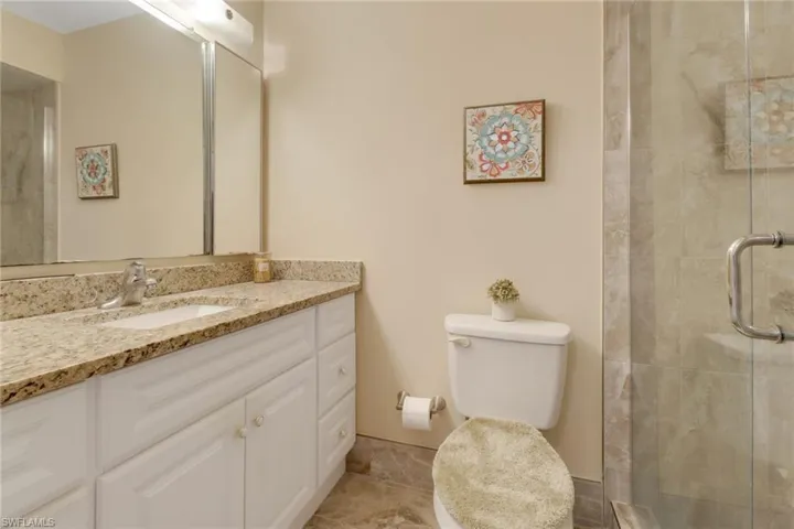 Primary bathroom with upgraded, frameless, glass-enclosed tiled shower