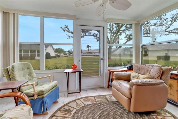 Sunroom / solarium with plenty of natural light and door leading to backyard