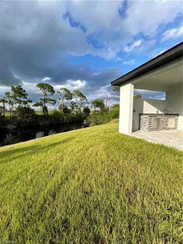 View of yard with a patio and a water view
