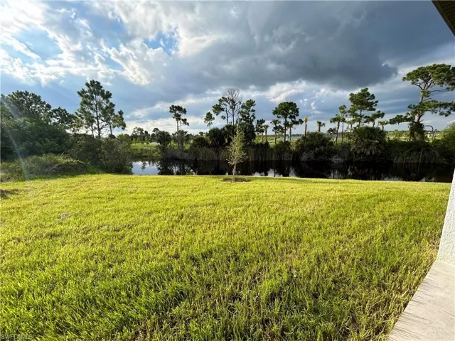 View of yard with a water view