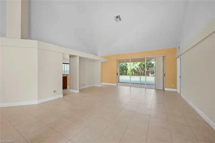 Volume ceilings and large stacking sliding glass doors from living room