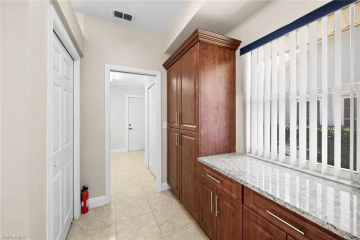 Desk area and additional storage between kitchen and laundry room