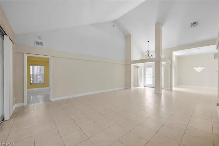 Entrance has beautiful high ceilings and great architectural elements. Formal Dining room off living area with sliding glass door can be converted to office area or additional bedroom.