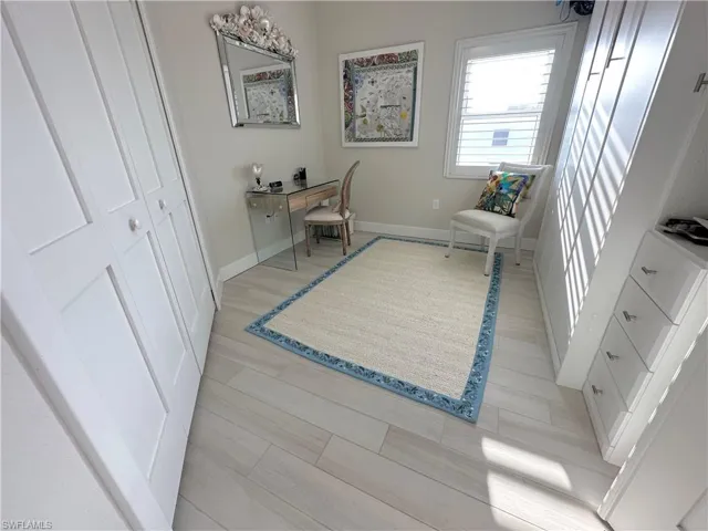 Office space featuring baseboards and light wood finished floors