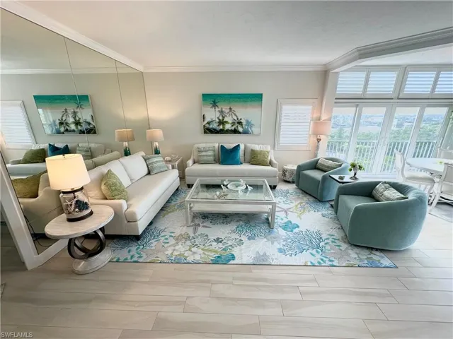 Living area featuring ornamental molding and wood finish floors