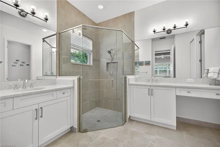 Note the Upgrades of seamless shower door and floor to ceiling tiles in shower are vanity area, ladies!