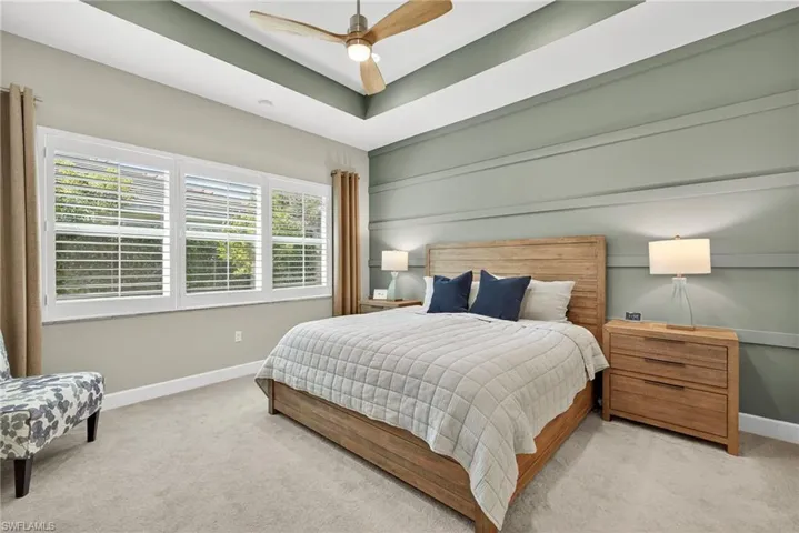 Lovely accent wall  and plantation shutters make this primary bedroom special. Large enough to hold a king sized bed, 2 nightstands, a chair and a triple dresser!