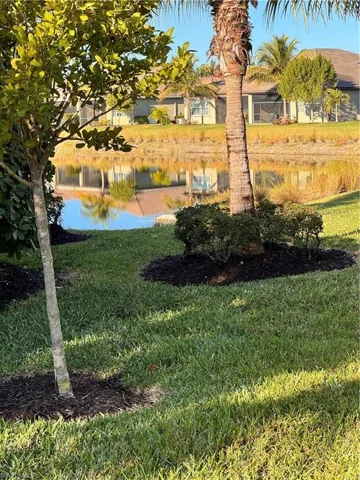 View of grassy yard with a water view