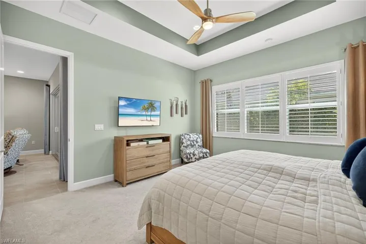 Three windows make for a bright and cheery primary bedroom!