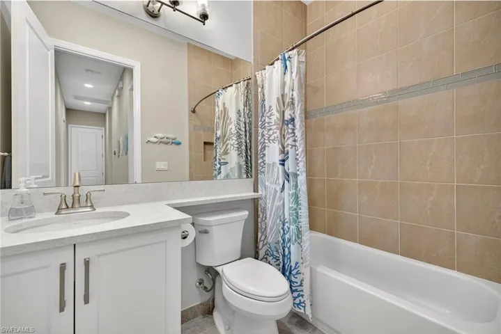 shared bath for guest features upgraded floor to ceiling tiles