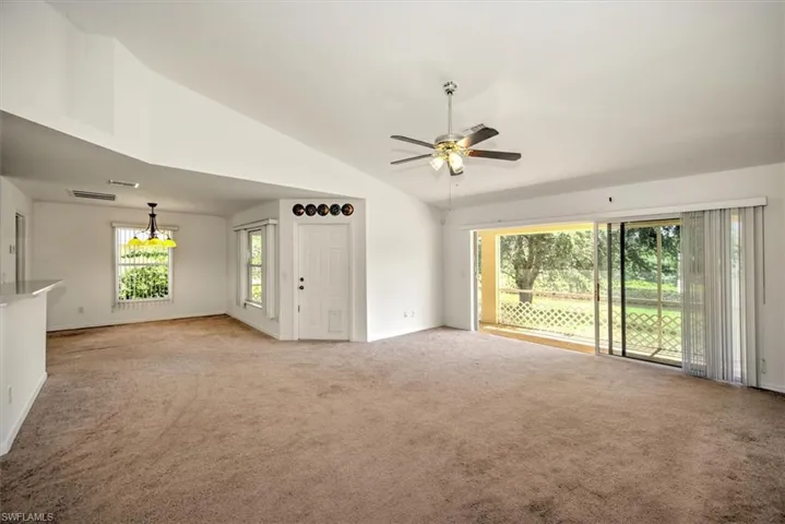 Great room with high vaulted ceiling, ceiling fan, and a wealth of natural light