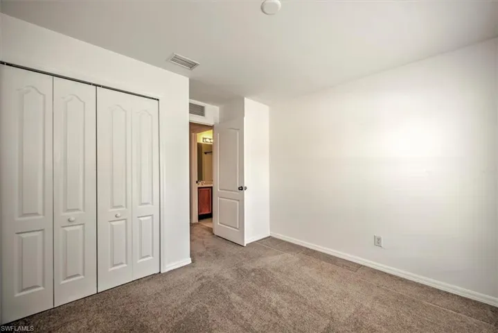 bedroom with carpet flooring and a closet