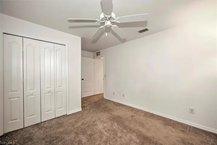 3rd bedroom featuring a closet, ceiling fan, and carpet floors