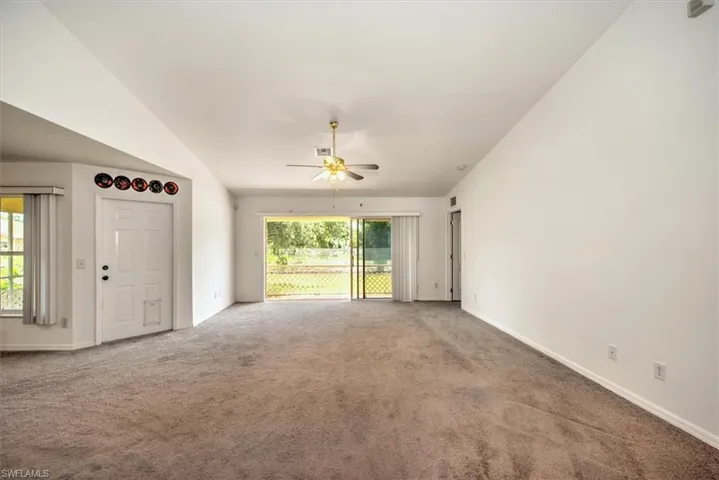 Great room featuring ceiling fan and vaulted ceiling