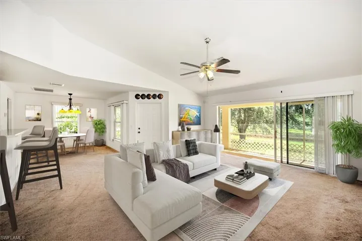 Great Room Staged featuring high vaulted ceiling, ceiling fan, and light colored carpet