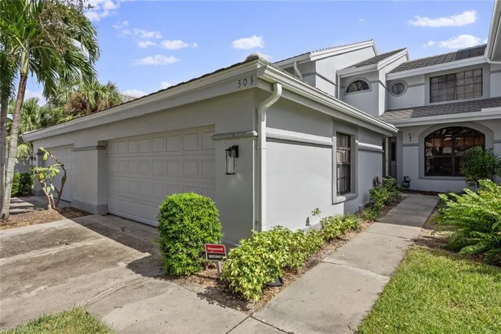 View of side of property with a garage