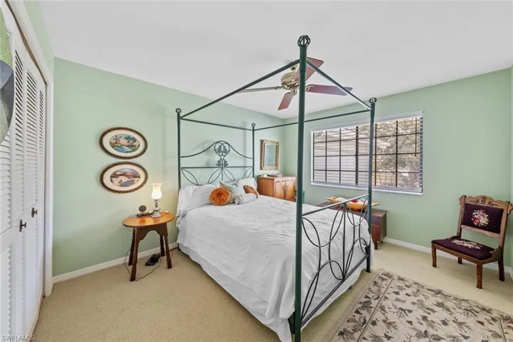 Bedroom with a closet, ceiling fan, and carpet floors