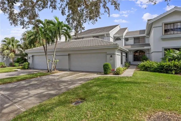 View of front of home with a front lawn and a garage