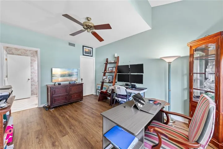 Office area featuring ceiling fan and dark hardwood / wood-style flooring