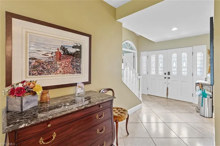 Entrance foyer featuring light tile patterned flooring