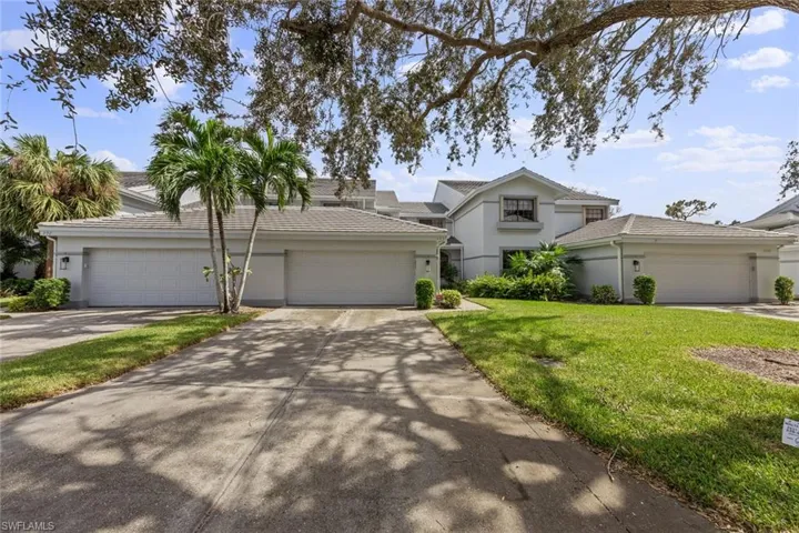 Front of property with a front yard and a garage