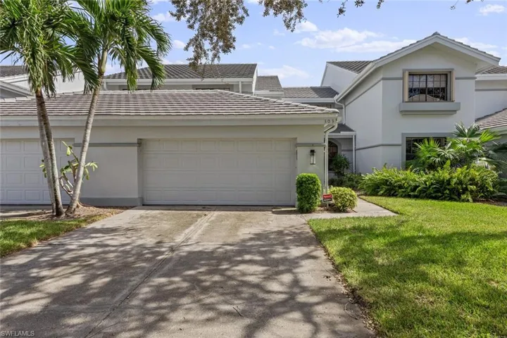 View of front of home with a front lawn and a garage