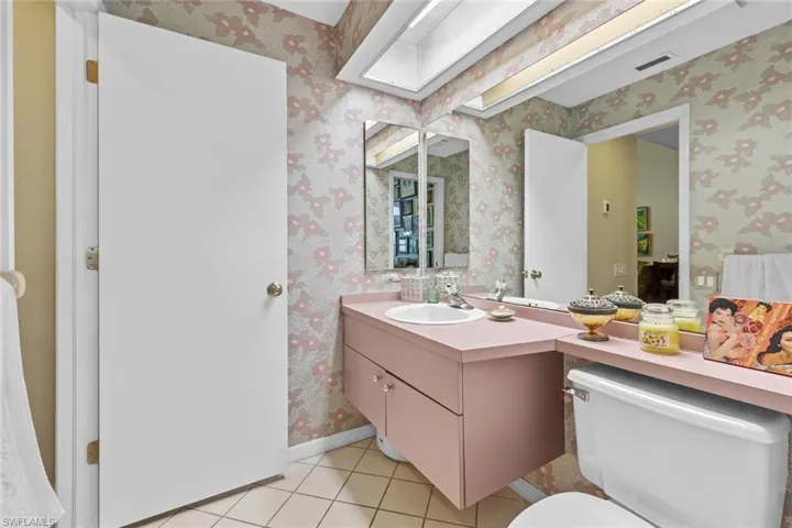 Bathroom featuring toilet, vanity, and tile patterned floors