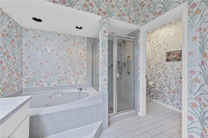 Bathroom featuring vanity, tile patterned floors, and independent shower and bath