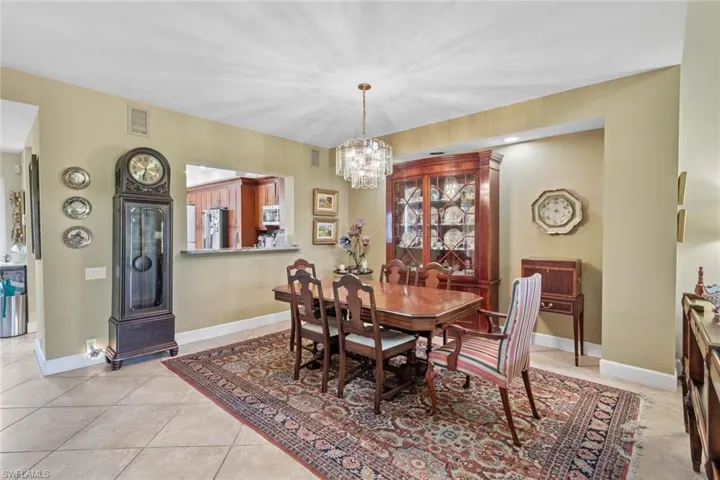 Tiled dining room featuring a chandelier