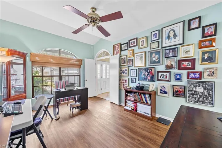 Office area with lofted ceiling, wood-type flooring, and ceiling fan