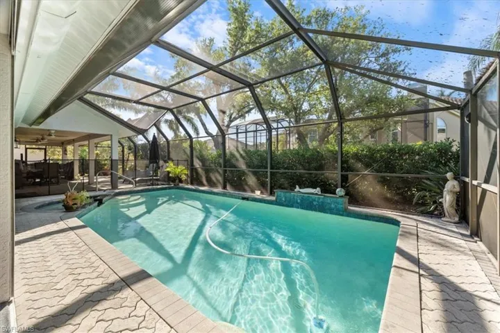 Outdoor pool with glass enclosure and a patio