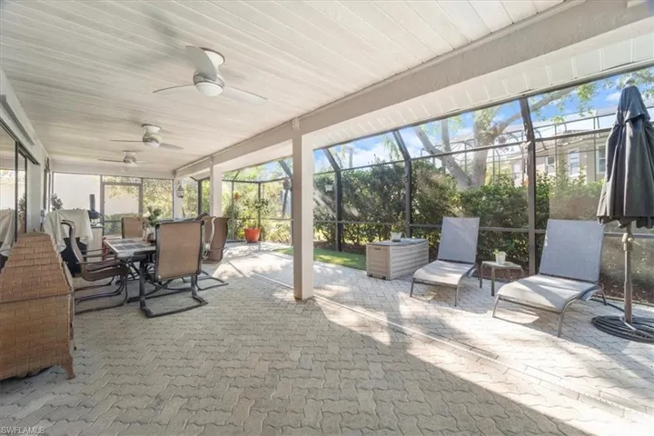 Sunroom with wooden ceiling and ceiling fan