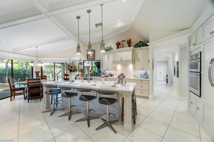 Kitchen featuring light tile patterned floors, visible vents, hanging light fixtures, and light countertops