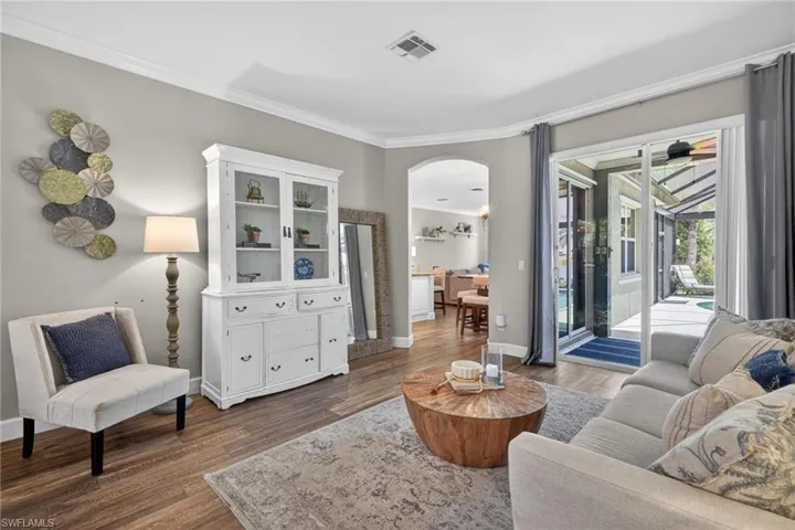 Formal Living Room with Crown Molding & Sliders