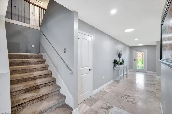 Stairway featuring baseboards and recessed lighting