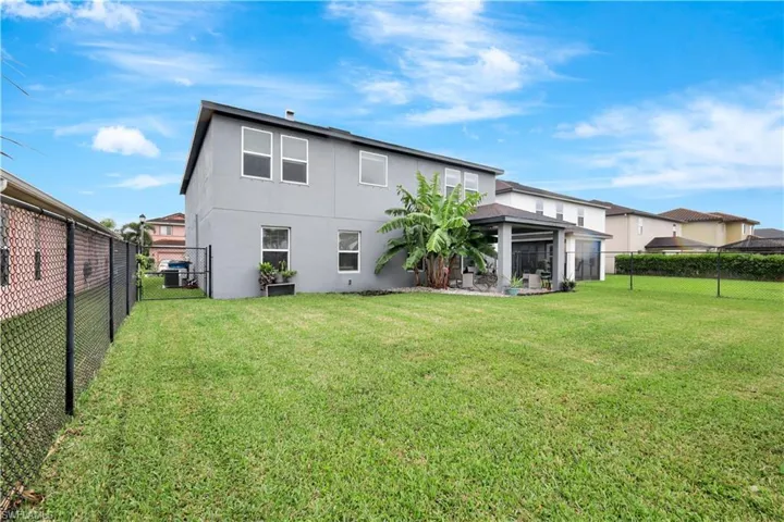 Rear view of house with a fenced backyard, a patio, and stucco siding