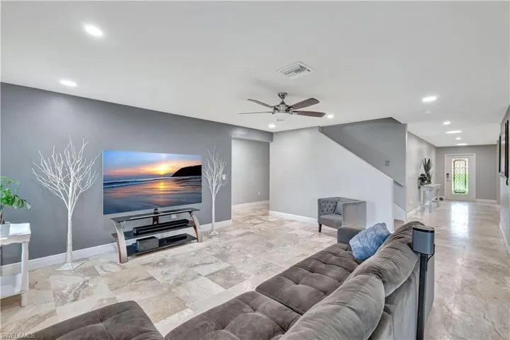 Living area featuring recessed lighting and a ceiling fan