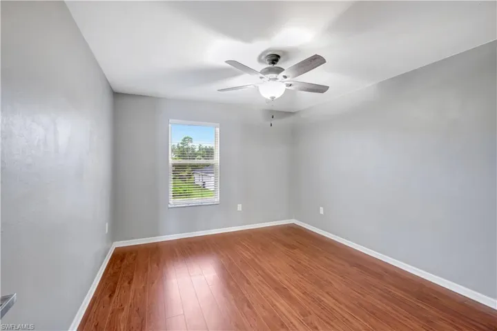 Unfurnished room featuring wood finished floors and a ceiling fan