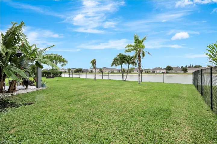 Fenced backyard with a residential view and a water view