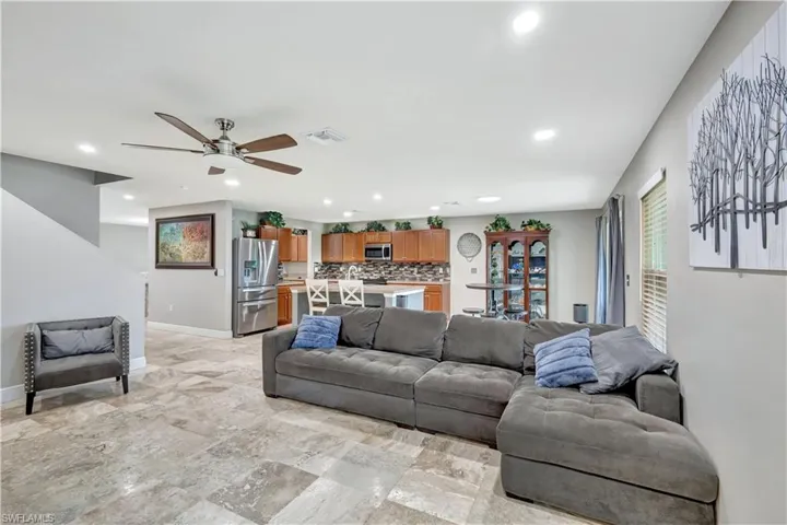 Living area with recessed lighting and a ceiling fan