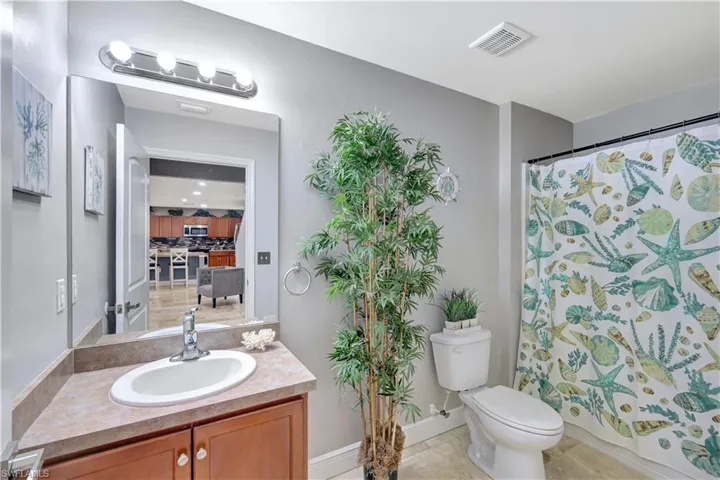 Bathroom featuring vanity, light tile patterned flooring, and backsplash