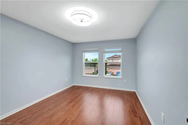 Empty room featuring wood finished floors and baseboards